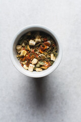 Overhead view of dehydrated mixed vegetables in a white ramekin, top view of mixed dried vegetables on a white countertop