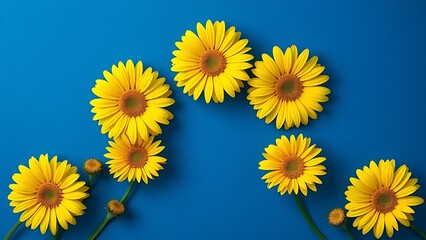 Vibrant yellow gerbera daisies arranged in geometric pattern against deep blue background.