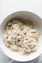 overhead view of savory biscotti dough in a bowl, top view of savory cookie dough in a mixing bowl
