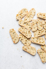 Overhead view of toasted bread chips on white background, top view of crostini bread on marble countertop