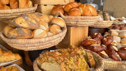 A luxurious hotel breakfast features an extensive selection of baked goods including croissants, bagels, muffins, pastries, breads, cookies, pancakes, waffles, scones, biscuits, donuts, rolls, Danish 