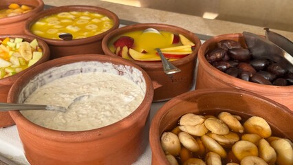 A luxurious hotel breakfast features an extensive selection of baked goods including croissants, bagels, muffins, pastries, breads, cookies, pancakes, waffles, scones, biscuits, donuts, rolls, Danish 