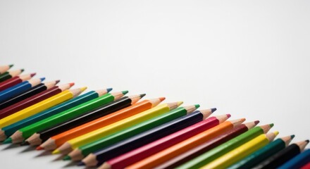 Naklejka premium Colorful pencils in a row against a white background