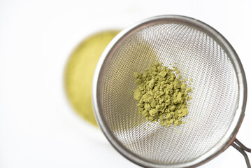 Top view of matcha green tea powder in sieve prepare for tea mixing