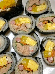 Delicious kimbap rolls filled with fresh vegetables, seasoned rice, and savory proteins, all wrapped in crisp seaweed. A perfect combination of flavor and texture in every bite.