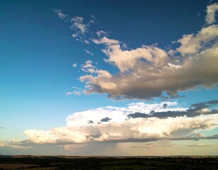 Wide-shot view of a partly cloudy sky over a landscape