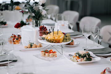 Elegant table setting with fresh fruits and gourmet dishes for a special event