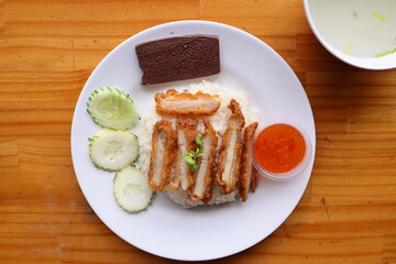 Culinary Delight: A visually captivating top-down shot showcases a plate of enticing Hainanese chicken rice, complemented by flavorful sides, creating a feast for the eyes.