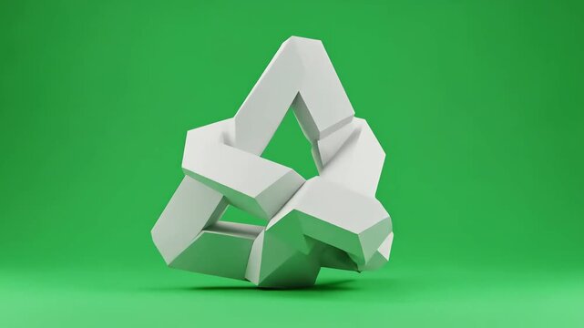 Impossible triangle optical illusion sculpture on a green background