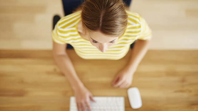 concentrating. Overhead view of a focused person working at a minimalist desk with soft natural lighting. lifestyle magazines.