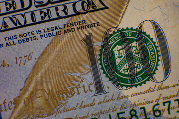Detailed view of a 100 dollar bill showcasing the design and security features, highlighting its historical significance and value