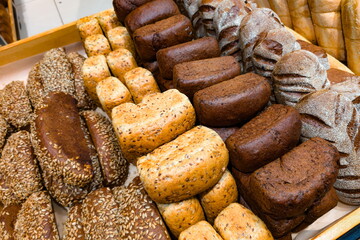 Freshly baked artisan bread displayed at a local bakery showcasing various textures and flavors on a bright afternoon