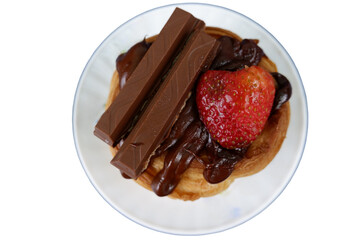 Delicious waffle topped with chocolate, strawberry, makes it look so appetizing and perfect for sweet treat