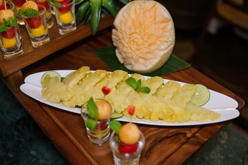 Exotic Fruit Display: An array of beautifully arranged tropical fruits, artistically sliced and...