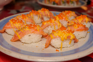 Salmon Nigiri: Artistically arranged salmon nigiri, showcasing the culinary craftsmanship of traditional Japanese cuisine, offering a visual feast of flavor and texture.