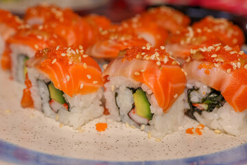 Sushi Delight: A close-up shot of meticulously crafted sushi rolls, each showcasing the freshness and vibrant colors of its ingredients.