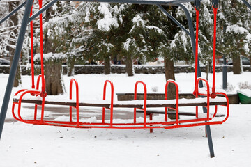 frozen swing trail shape in winder cold frosty park ordinary city square place in snowy environment