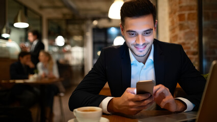 Man in a suit is looking at his cell phone