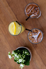 iced coffee and lemonade on wooden table top view