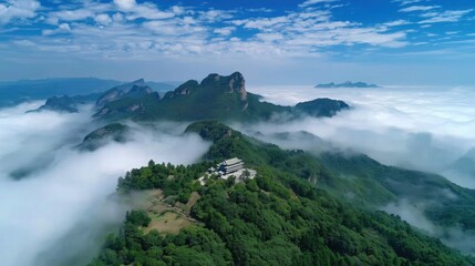 Aerial View of Serene Mountain Landscape Surrounded by Ethereal Clouds under Bright Blue Sky