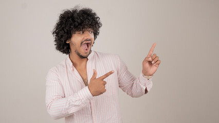 Young man in pink striped shirt showing expressions and hand gestures