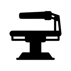 Silhouette of an Examination Table with Adjustable Overhead Light Fixture