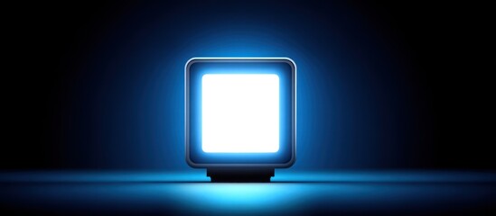 A glowing, square-shaped, illuminated object in a dark, blue-lit setting. A glowing screen