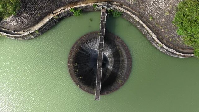 Circular Morning Glory Spillway in Hong Kong reservoir landscape Aug 9 2025