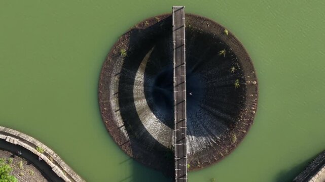 Circular Morning Glory Spillway in Hong Kong reservoir landscape Aug 9 2025