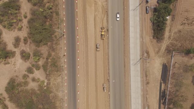 Aerial view drone footage of bridge construction being made across the intersection