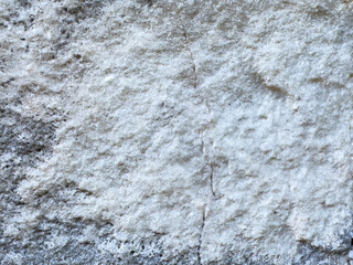 Close-up of rough gray stone texture with natural patterns