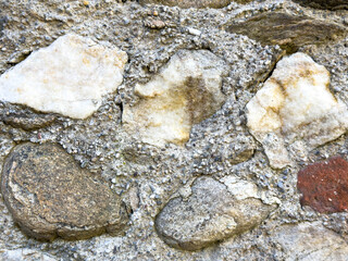 Weathered stone and rock wall texture with varied colors and textures