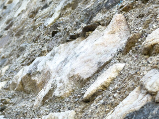 Rocky geological formation with rough texture and sedimentary layers