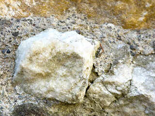 White quartz rock embedded in natural stone surface