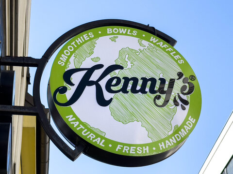 Wolfsberg, Austria - September 19, 2025: Kenny's cafe sign showcasing fresh, handmade smoothies, bowls, and waffles, emphasizing natural ingredients and vibrant design in a lively urban setting