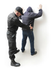 Man being searched by a policeman in black uniform