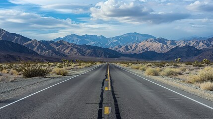 Naklejka premium Desert road scenery Arid Serenity: Breathtaking Desert Road Scenery – A Long, Winding Asphalt Road Stretching Through Golden Sand Dunes and Scattered Desert Shrubs, Under a Clear Blue Sky
