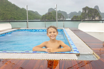 Happy european family, visiting Ha Long bay on a cruise with pool, visiting caves and landview...