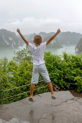 Fototapeta premium Happy european family, visiting Ha Long bay on a cruise with pool, visiting caves and landview points