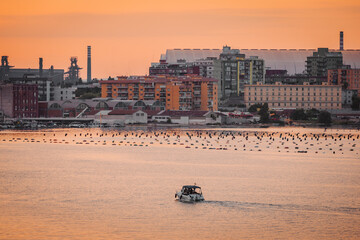 Boats and seaside houses in Taranto at dusk