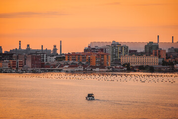 Orange sky and Taranto skyline reflection