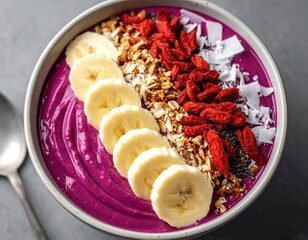 Delicious and vibrant smoothie bowl with fresh banana slices goji berries coconut flakes and granola toppings for a healthy breakfast or snack option