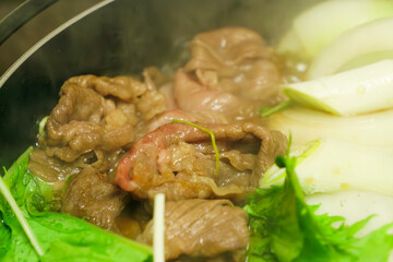 Sukiyaki, beef and vegetables simmered to perfection, a juicy and warm hot pot dish, steam rising