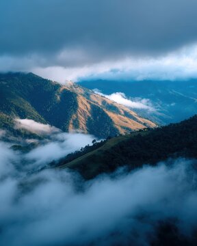 mountain ridge with clouds rolling over valleys, dramatic lighting