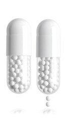 Two white medicine capsules, one releasing small white spheres, are displayed against a pure white background.