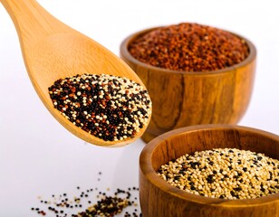 Quinoa varieties in wooden bowls and spoon