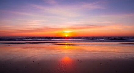 Obraz premium Vibrant sunset over the ocean with a reflection on the wet sand.
