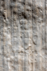 Close-up of grungy aluminum surface with dents and scratches