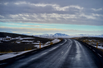 Road number 1 for travel in Iceland after rainy day and mountain view.