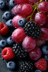Background. Ripe blackberries, blueberries, pink grapes, raspberries.
